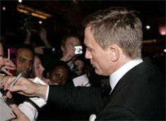 Daniel Craig signs autographs for waiting fans