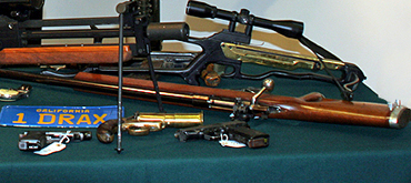 Mark Williams poses with a selection of guns at Christie's October2006