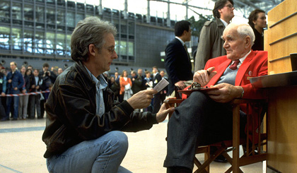 Desmond Llewelyn on the set of Tomorrow Never Dies (1997) with director Roger Spottiswoode